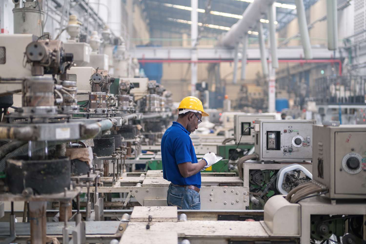A man works in a manufacturing plant.