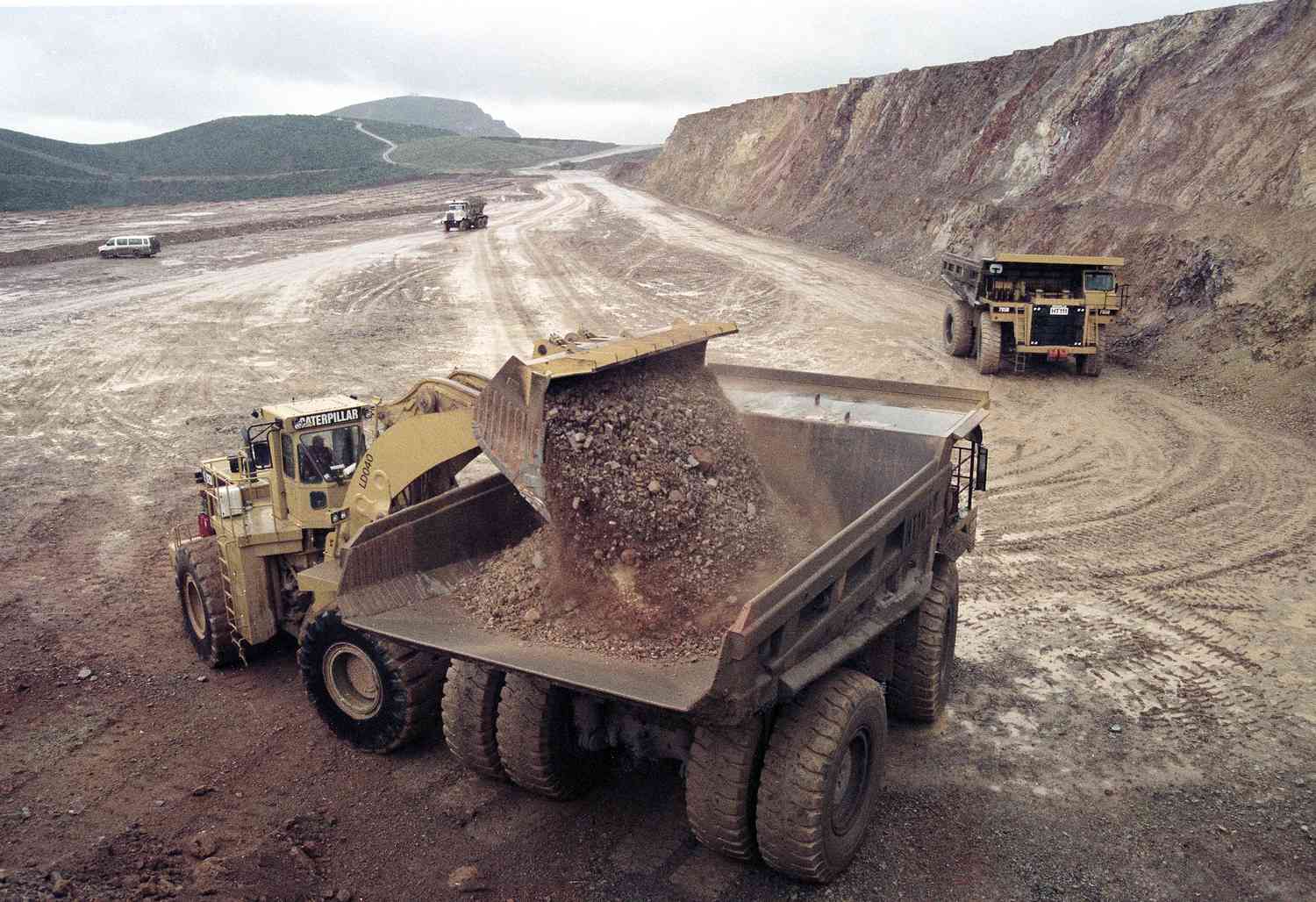 Dirt containing micro-particles of gold is loaded onto a dump truck at a Newmont Gold Company mine.
