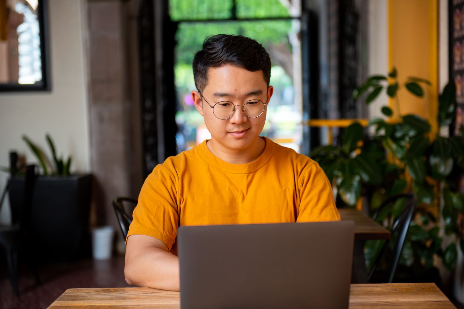 A student researches on laptop to see whether student loans are predatory.