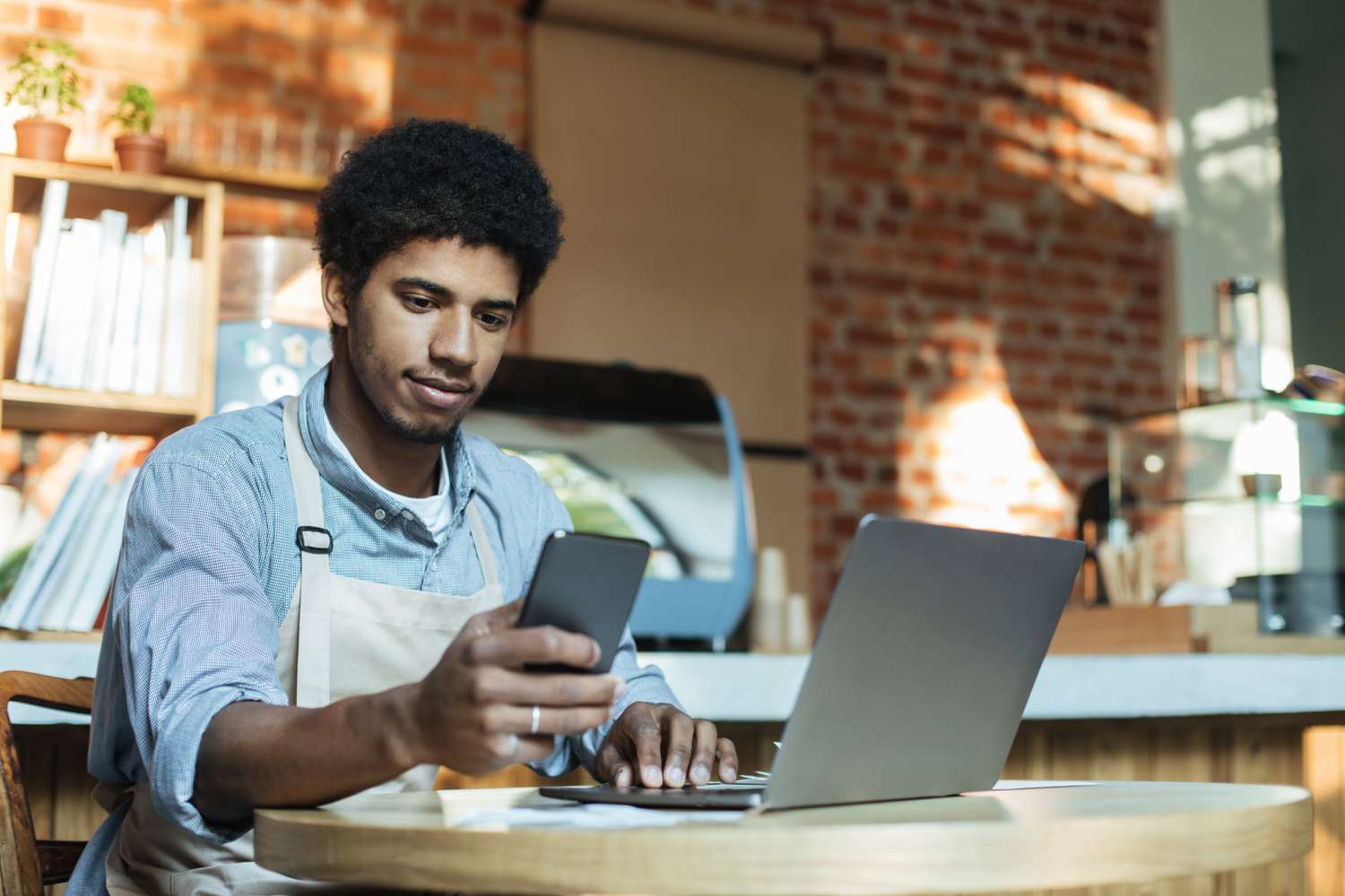 Small business owner considering applying for a loan to expand business when the interest rate is lowered by central bank. 