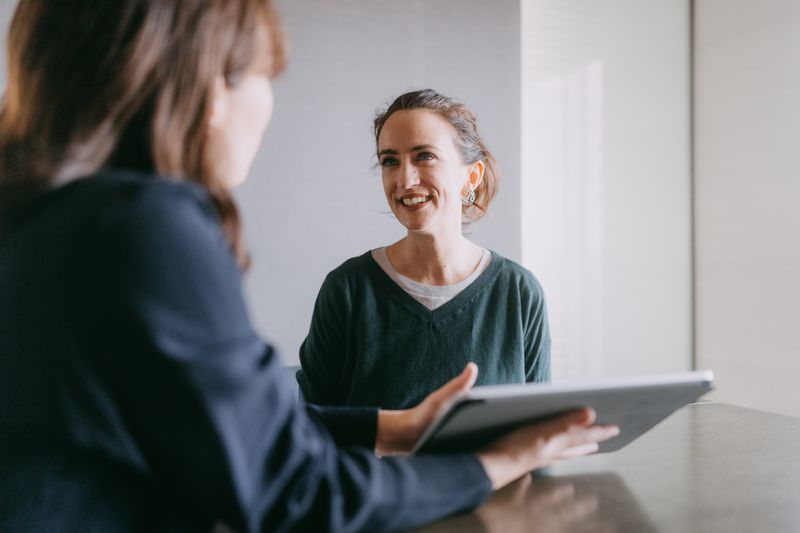 Woman talking with a realtor.