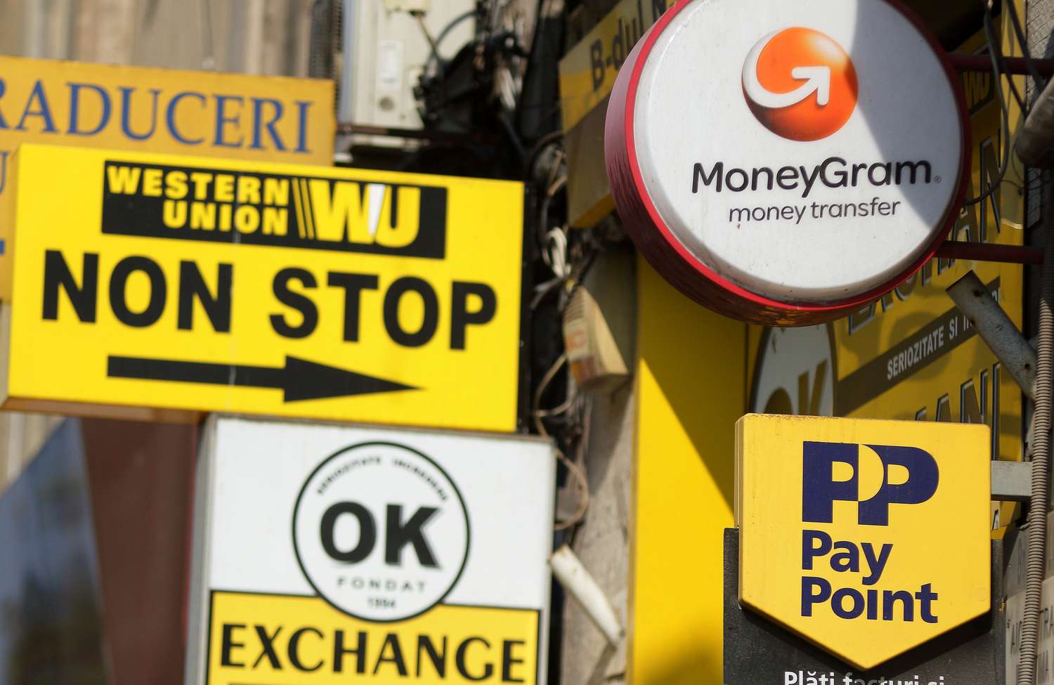 October 10, 2018: Several Western Union, MoneyGram and Pay Point commercials are seen on a street in downtown Bucharest. 