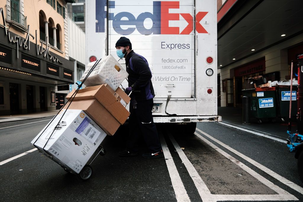 FedEx worker unloads packages