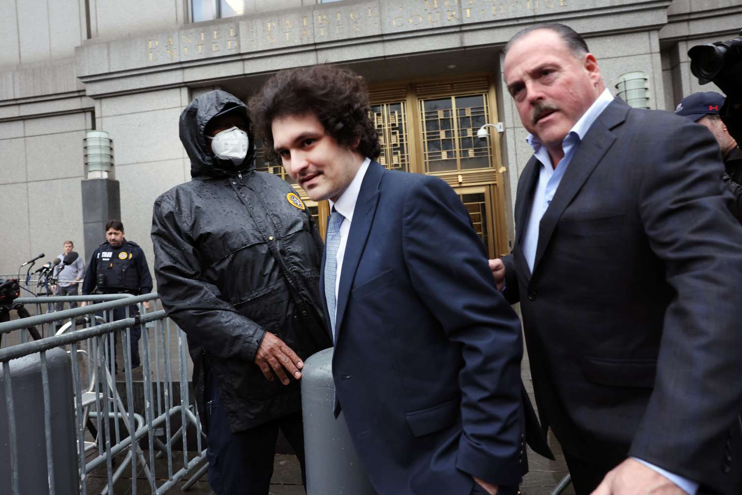 Sam Bankman-Fried being escorted by official