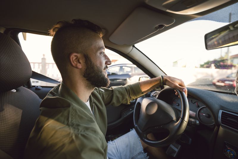 A man drives a car.