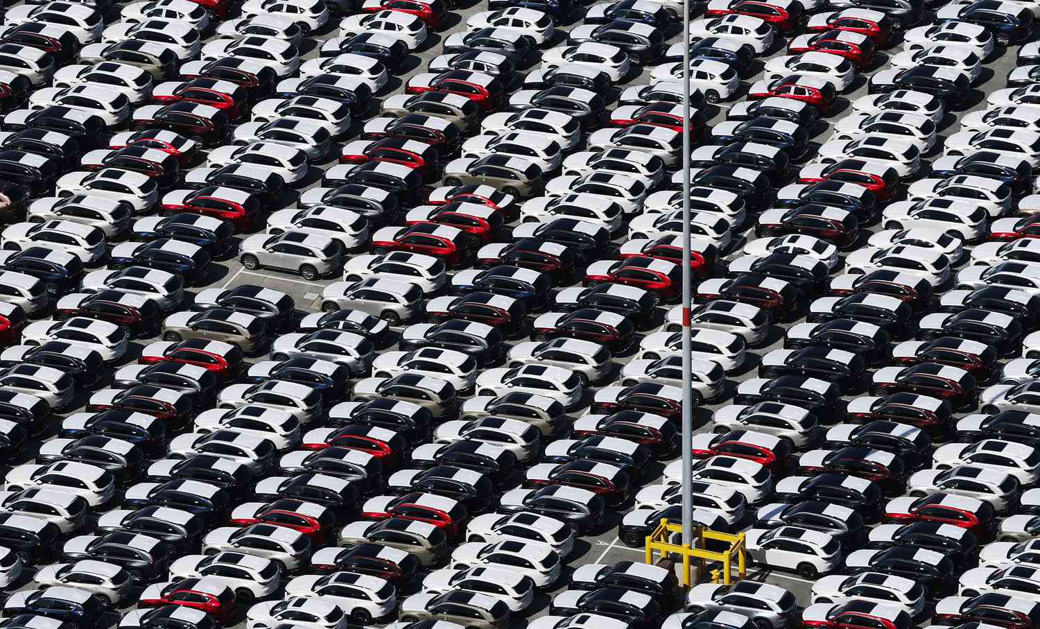 Rows of cars sit in a lot at the Port of Los Angeles.