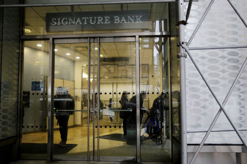 NEW YORK, NEW YORK - MARCH 13: People wait inside the Signature Bank branch on March 13, 2023 in New York City. Signature Bank a $110 billion commercial bank with offices in California, Connecticut, Nevada, New York and North Carolina, was closed by Regulators on Sunday the customers alarmed by SVB yanked their funds.