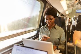 A woman on the train multi-tasking.