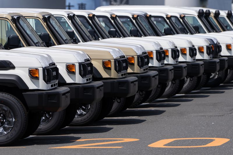 Toyota trucks awaiting shipment are parked at a port on March 27, 2025 in Yokohama, Japan