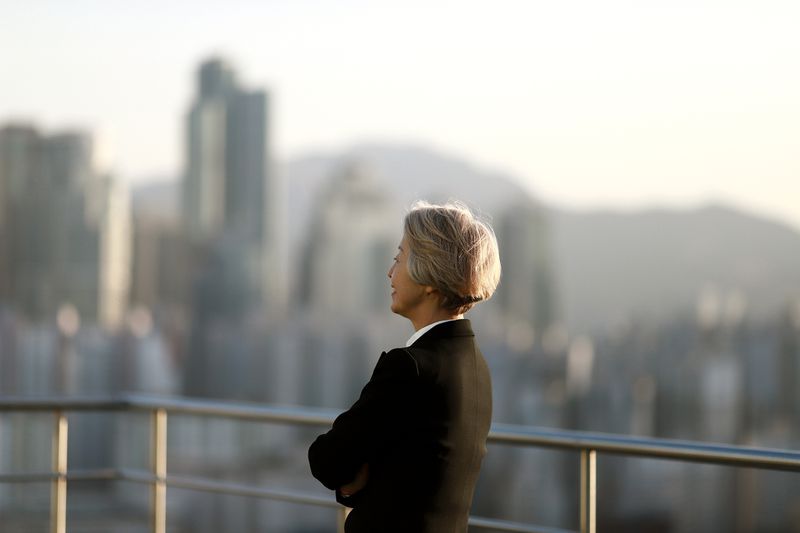 Female CEO standing on building rooftop