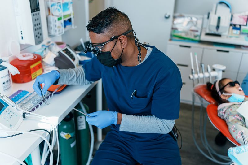 Dentist preparing for dental procedure