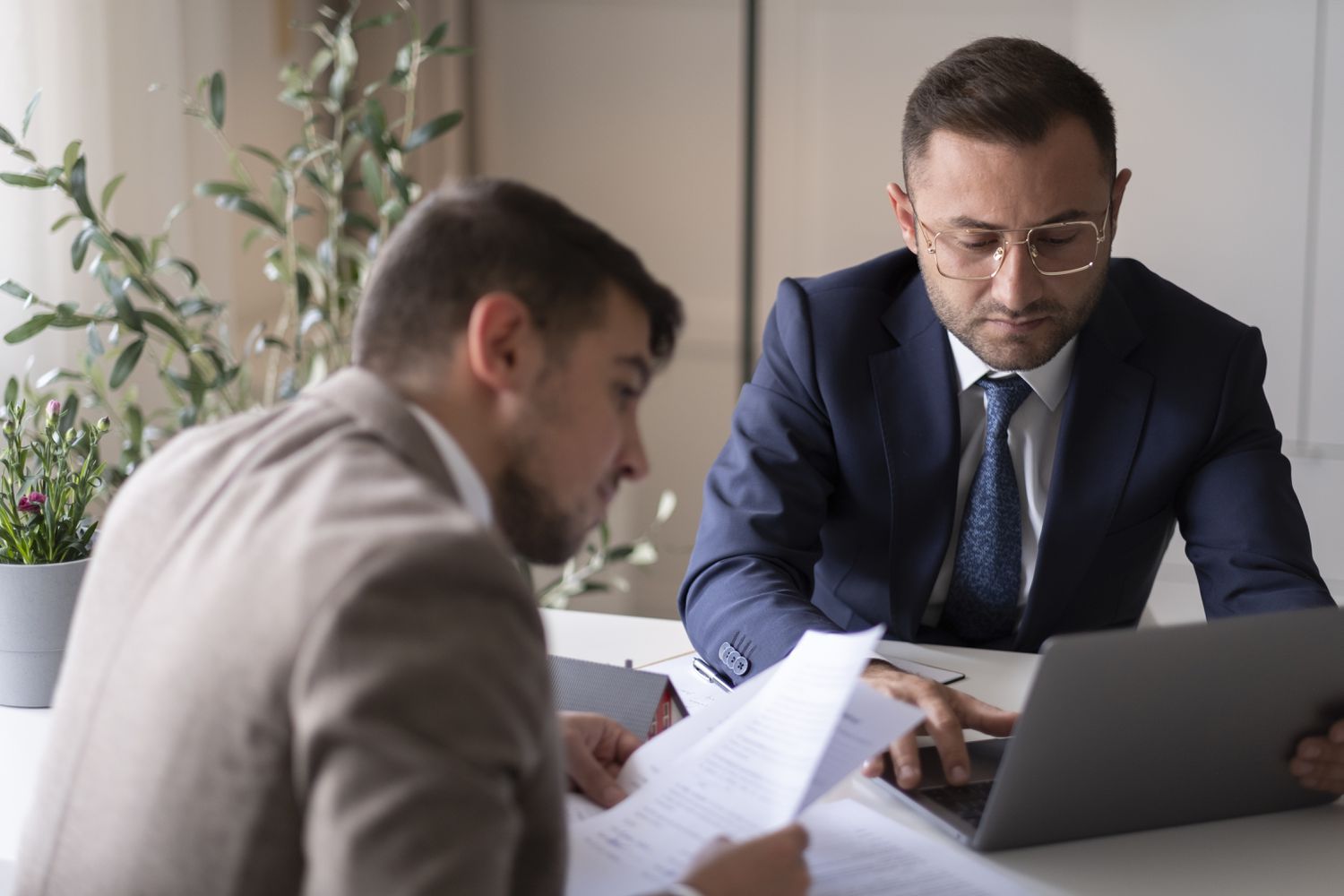 Mortgagees reviewing mortgage applications for approval.