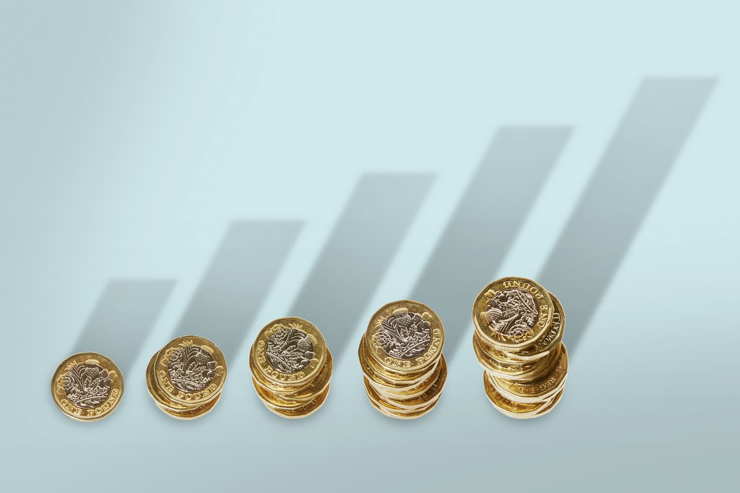 A set of rising coins with shadows forming graphs