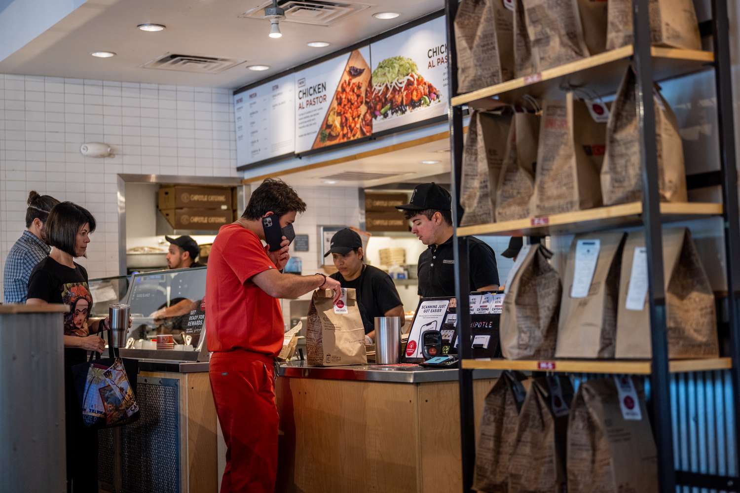 People order food at a Chipotle restaurant. 