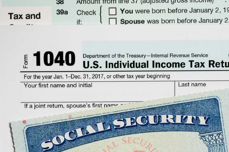 A social security card laid on top of Form 1040 tax return.