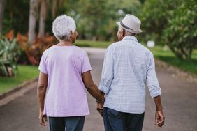Older couple walking in a park