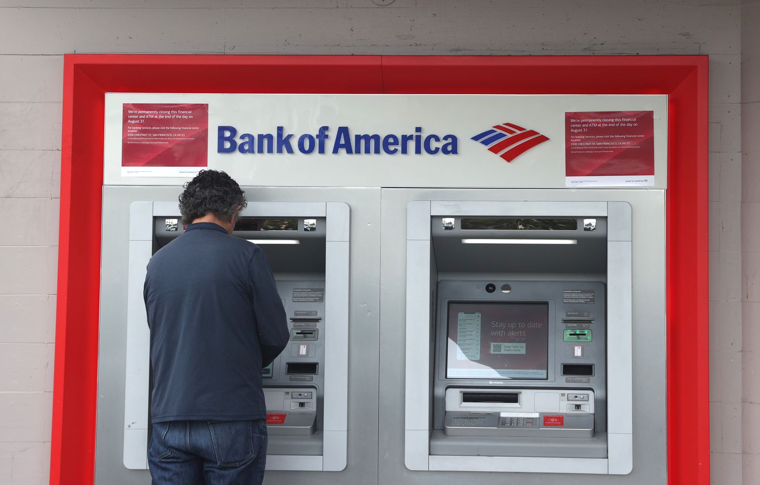  A Bank of America customer uses an ATM at a Bank of America branch office