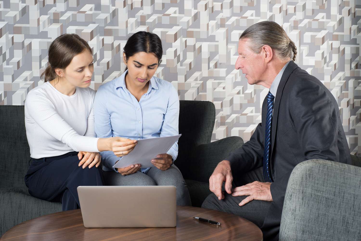 A young couple work with an attorney to create a trust that will allow them to easily pass retirement funds to their chosen beneficiary.