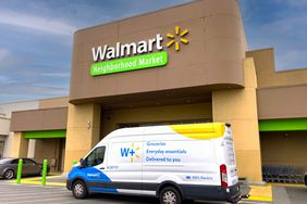 A delivery truck parked outside a Walmart Neighborhood Market