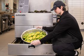 A Chipotle worker uses the company's "Autocado" machine. 