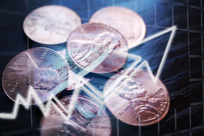 Pennies with a digital arrow across them.