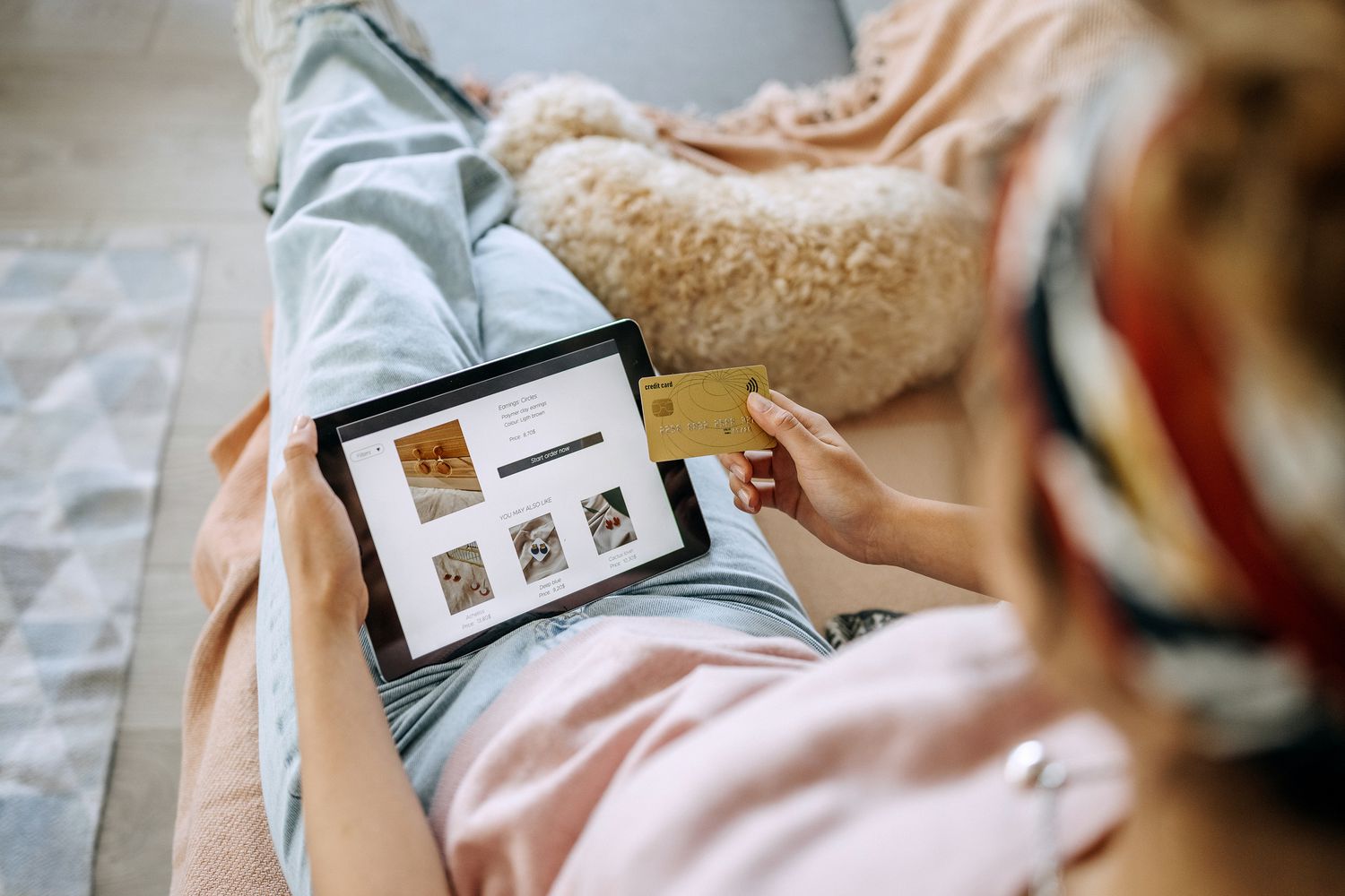 Young woman shopping for jewellery on a digital tablet.