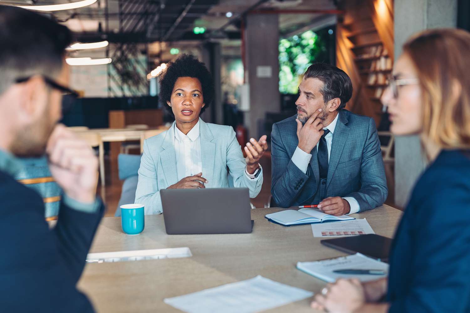 The directors and officers of a company gather around a conference table to discuss the upcoming annual meeting.