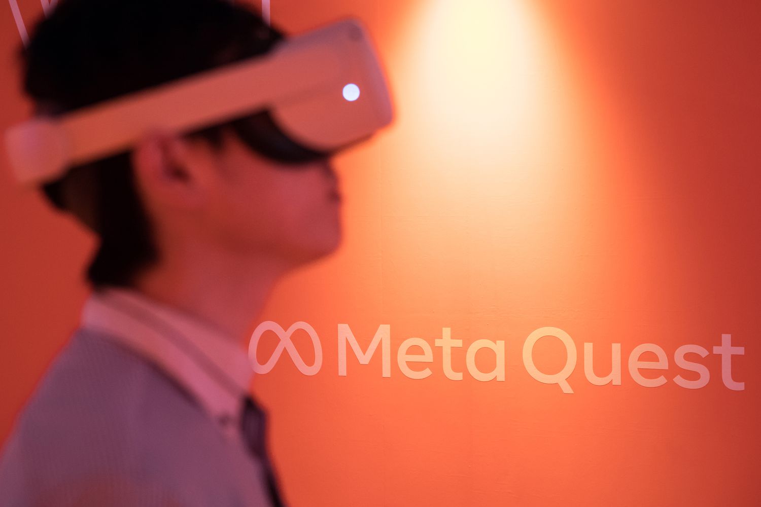 An attendee wearing a Meta Quest 2 VR headset plays a video game at the Tokyo Game Show.