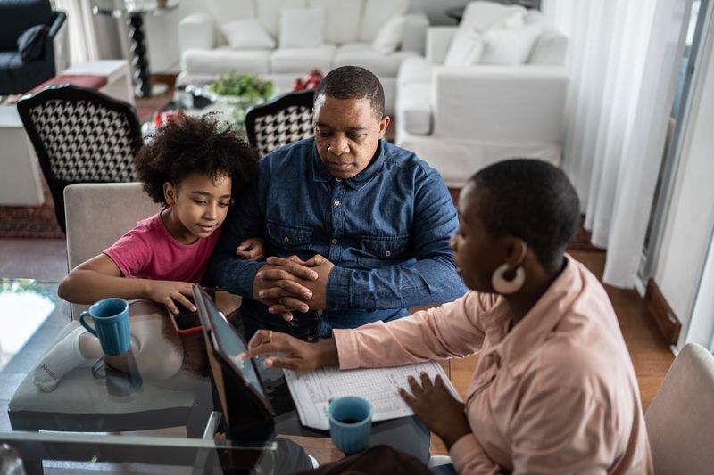Father and daughter checking with accountant about 529 plan