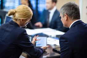 Colleagues in a business meeting with a tablet