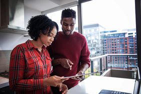 A couple researching for information about small business bank accounts for their business.