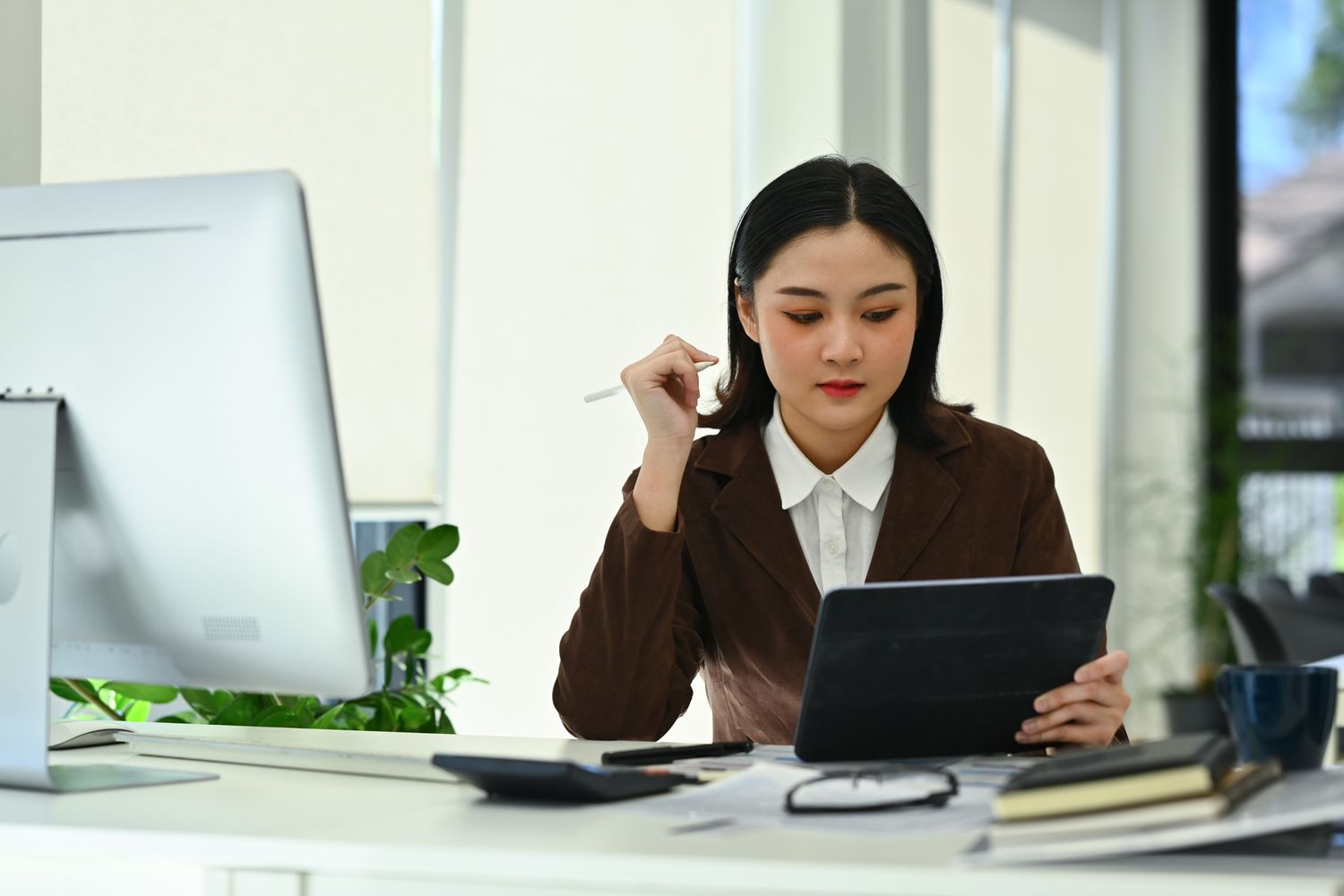 A person calculating tax on tablet.