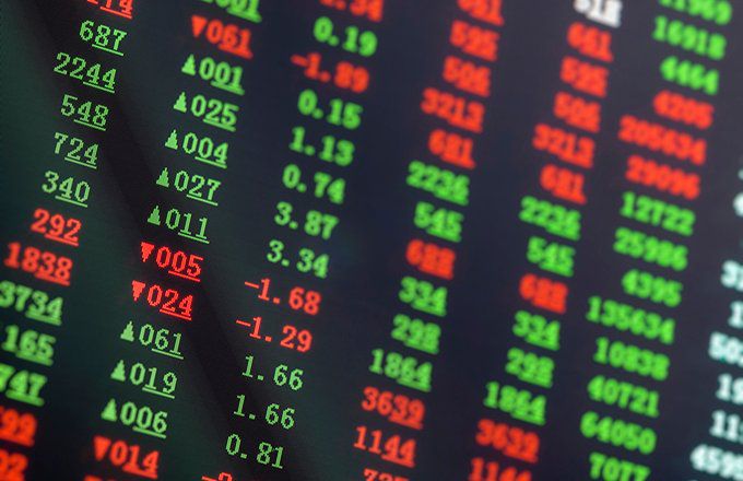 Red and green numbers showing stock prices going up and down.