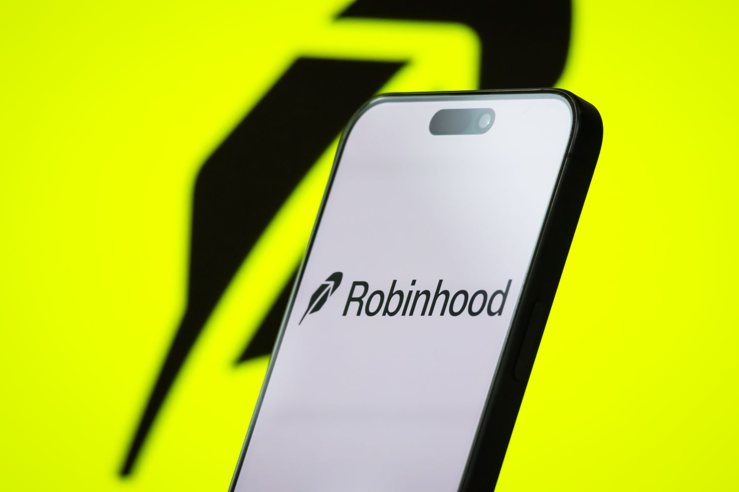 The logo of Robinhood Markets, Inc. is displayed on a smartphone screen, with the company's bright green branding visible in the background