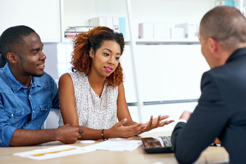 A shot of a young couple consulting a financial advisor.
