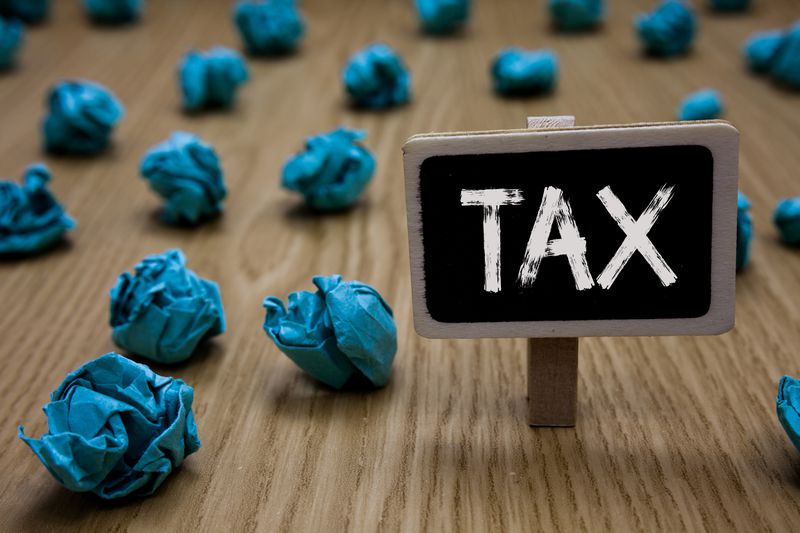 Writing note showing Tax. Business photo showcasing Compulsory payment of taxes by people to government increase revenue Cyan paper imagination idea crumpled papers mistakes several tries.