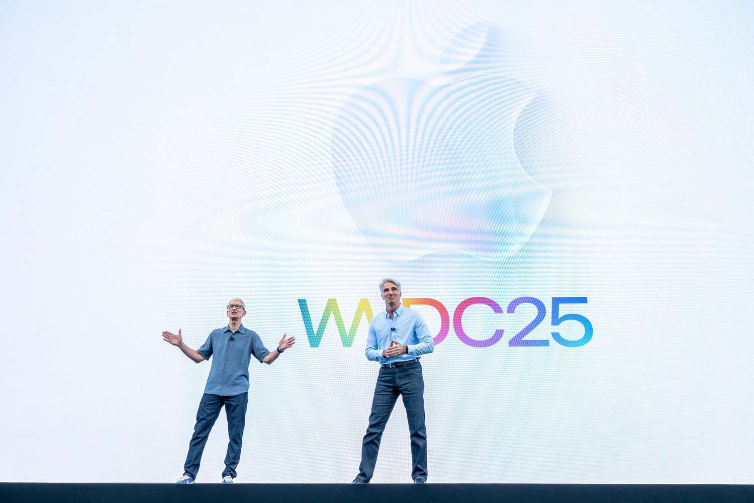 Tim Cook, chief executive officer of Apple Inc., left, and Craig Federighi, senior vice president of software engineering at Apple Inc., during the Apple Worldwide Developers Conference (WWDC) at Apple Park campus in Cupertino, California, US, on Monday, June 9, 2025.