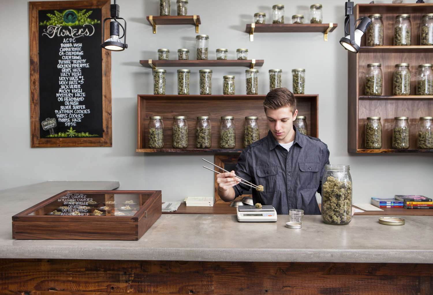 Person weighing marijuana buds at a dispensary in Portland