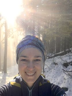 A photo of Heather van der Hoop in a snowy forest.