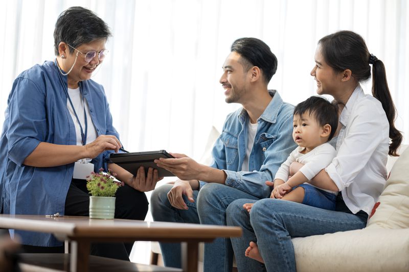 A couple with their child receiving advice from a financial advisor.