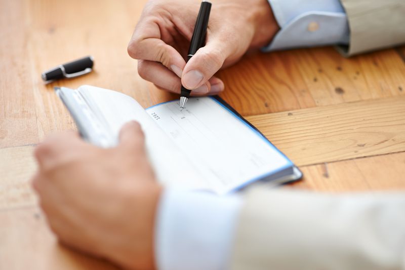 man signing check