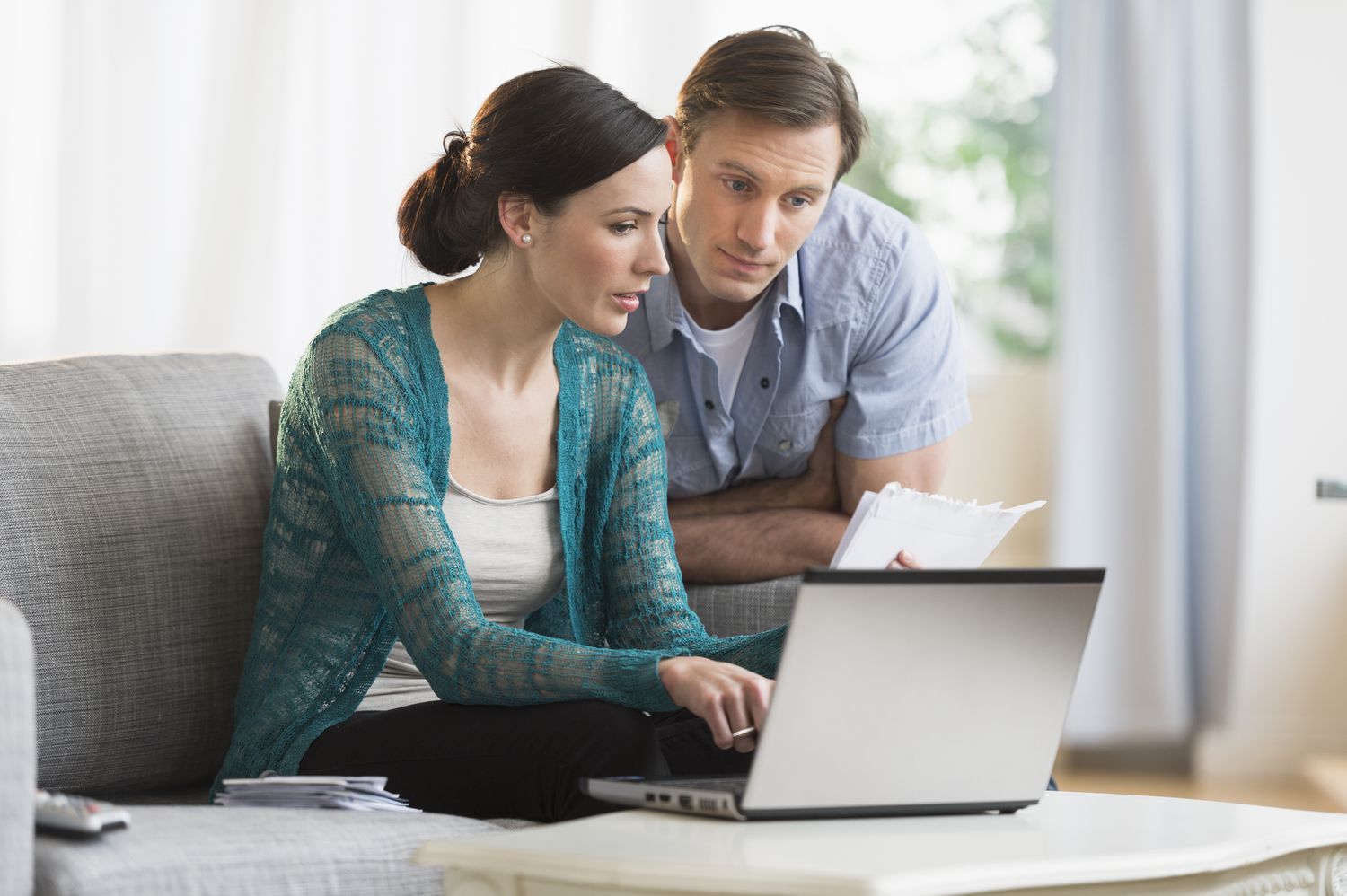 USA, New Jersey, Jersey City, Couple using laptop together to pay bills