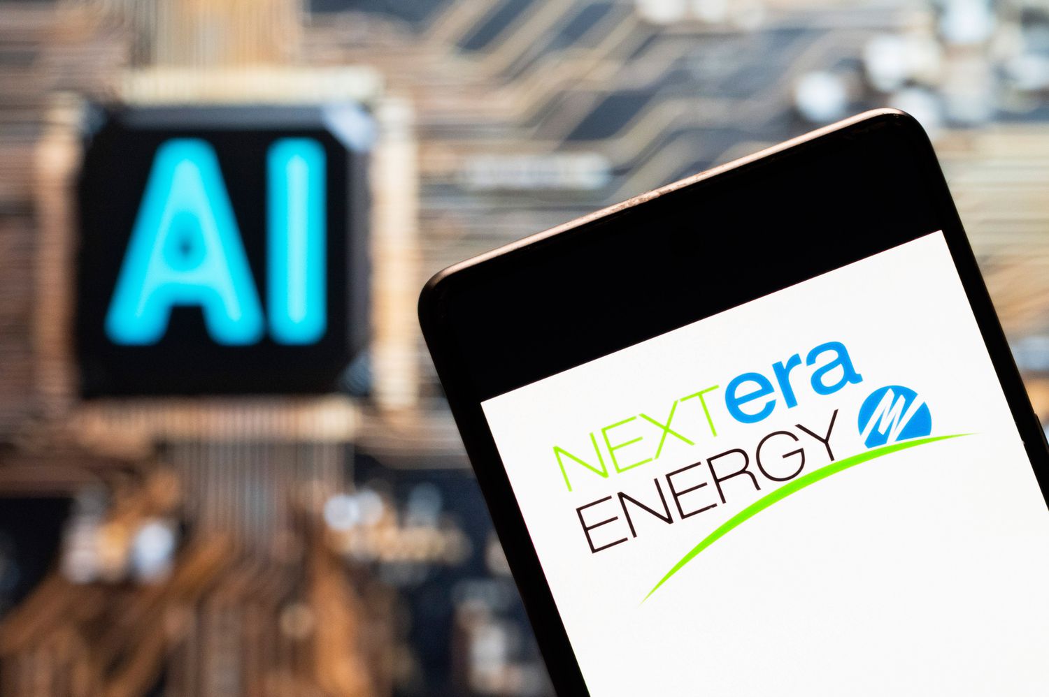 The NextEra Energy logo seen displayed on a smartphone with an artificial intelligence (AI) chip and symbol in the background