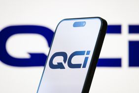 The logo of is displayed on a smartphone screen, with the company's branding visible in the background