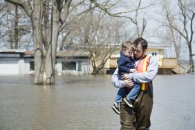 Man holding a child in the flood