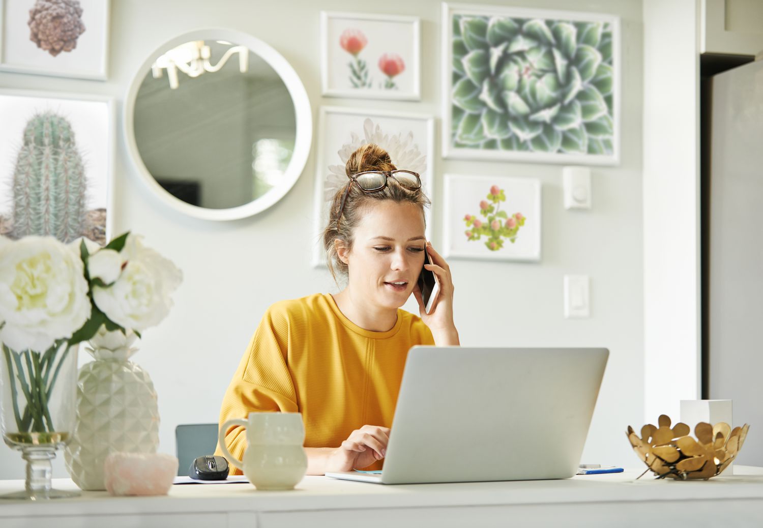 A person talking on the phone to request for annual credit report while sitting at home office.