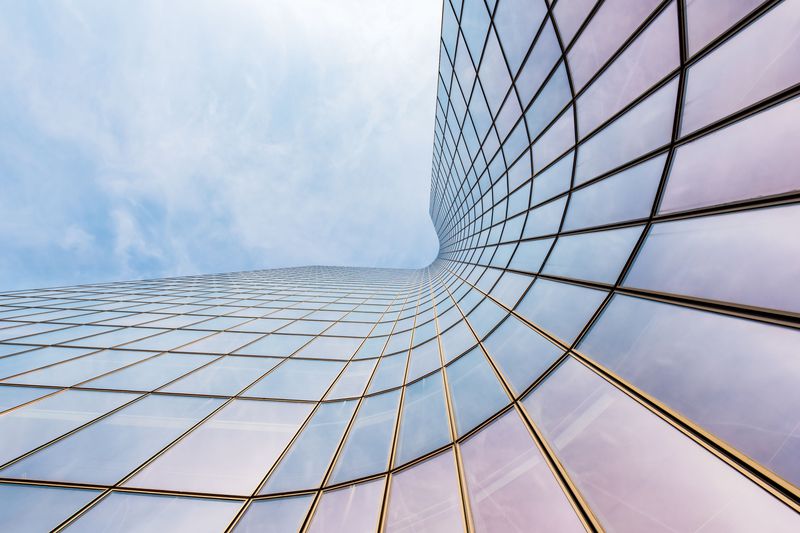 A curved skyscraper against a blue sky
