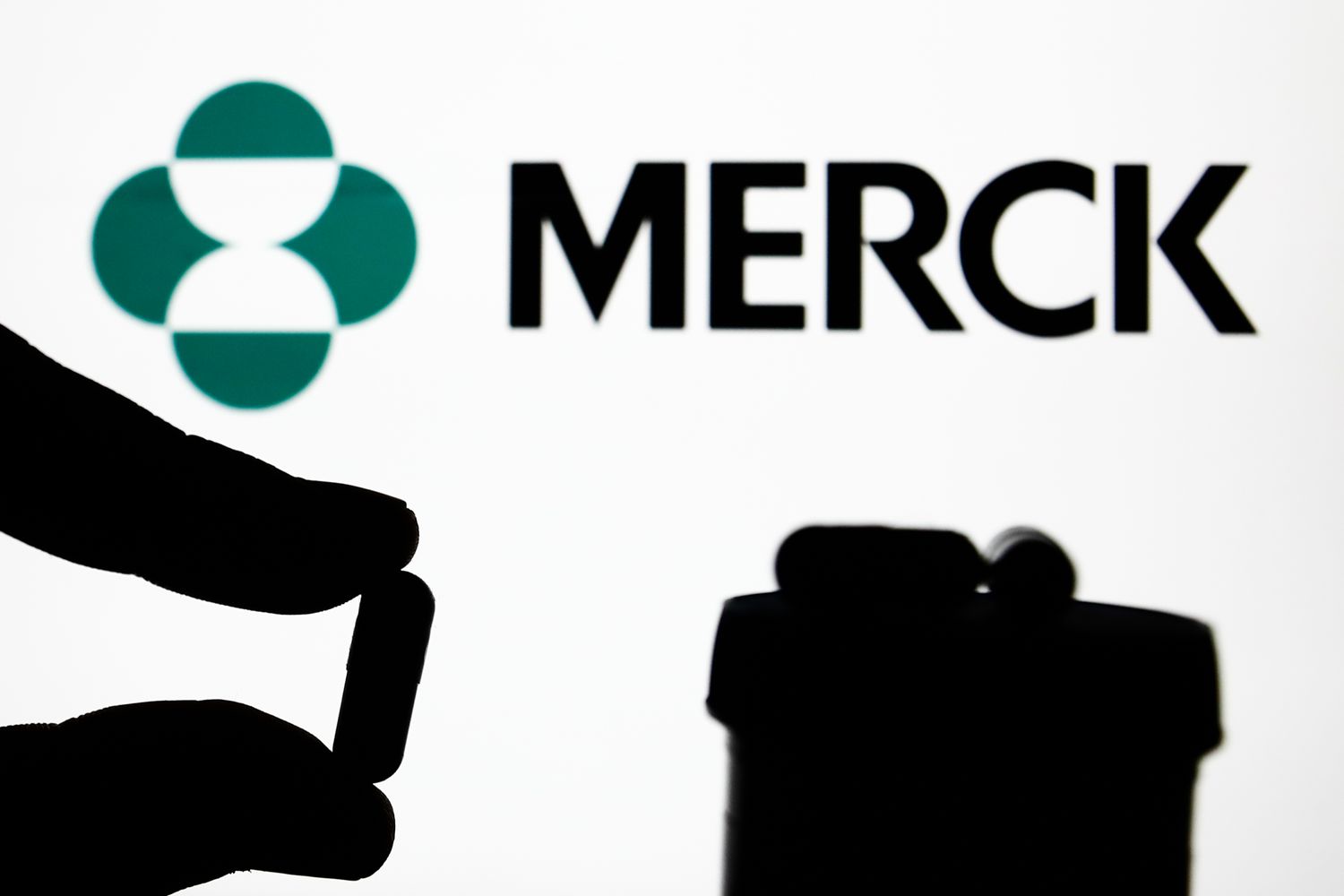 Medicine pill is seen with Merck logo displayed