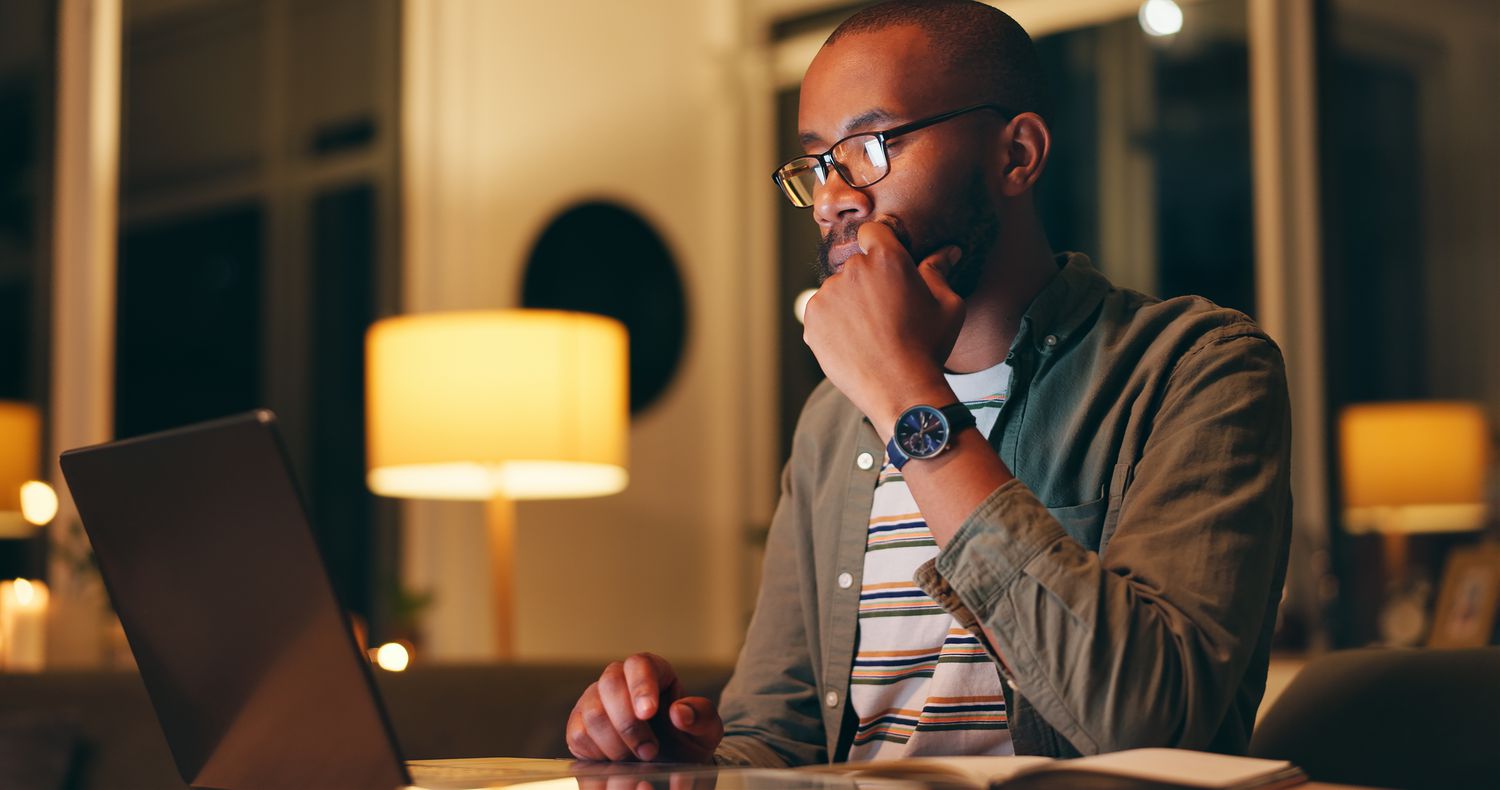 Man working on laptop at night