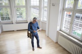 Man touring a new home after mortgage rates have dropped